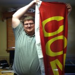 Jason Percival holding up the computer repair flag